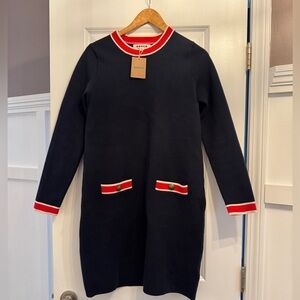 Navy Blue with red and pink accent at collar, cuffs and pockets.